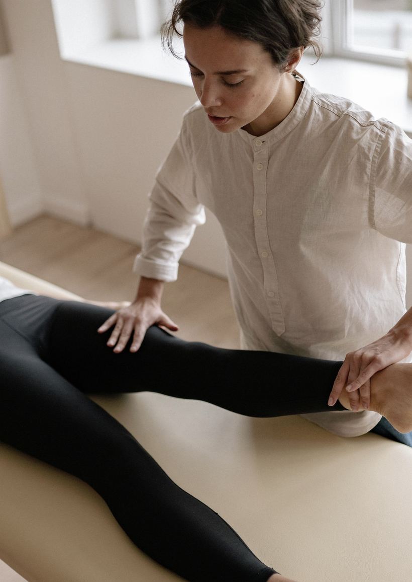Therapist treating a patient on a treatment table