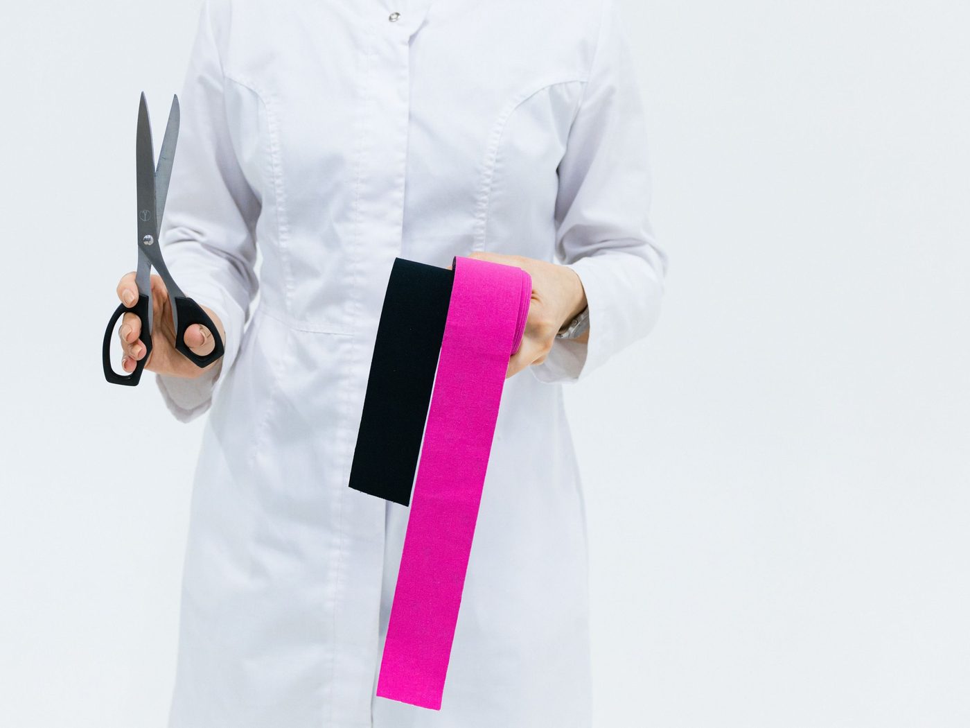 Therapist holding kinesiology tape in a clinic